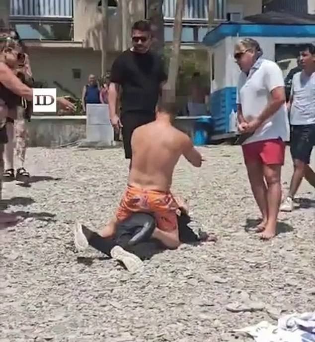 100931581-14971691-Dozens_of_boat_migrants_were_tackled_and_detained_by_tourists_af-m-30_1754386534446.jpg