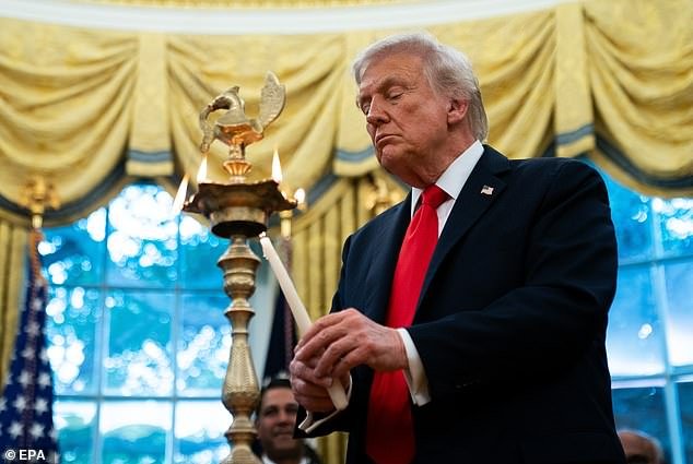 103228593-15217893-Donald_Trump_lights_a_diya_candle_during_a_Diwali_celebration_in-a-14_1761165770592.jpg