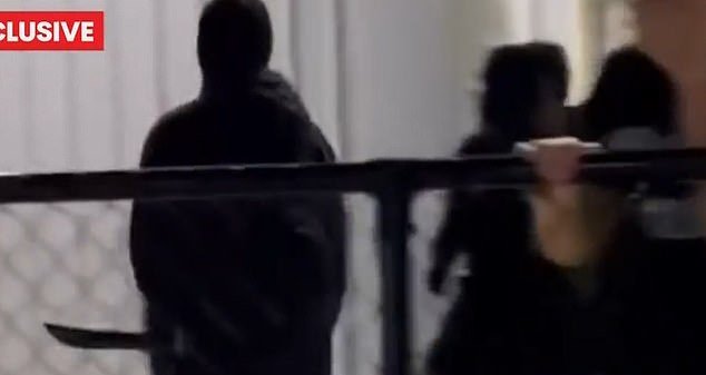 103320407-15228043-Hooded_youths_armed_with_machetes_were_seen_running_through_the_-m-4_1761453584738.jpg