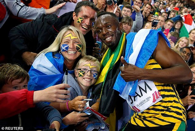 103729765-15274617-Usain_Bolt_with_delighted_fans_after_the_4x100m_relay_final_in_G-a-20_1762717364345.jpg